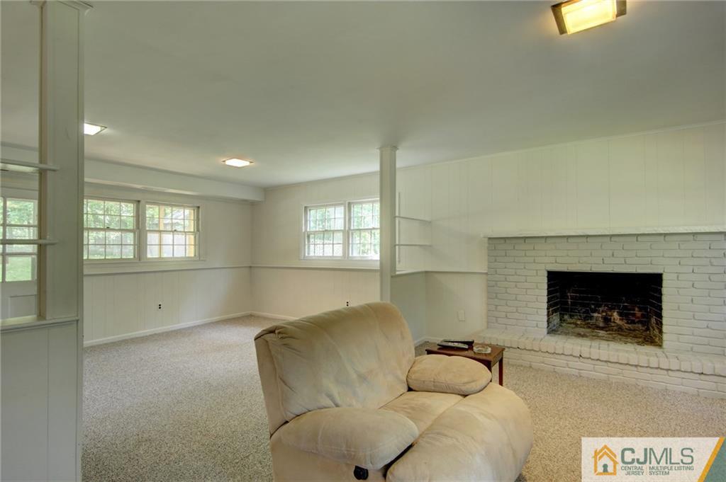 50 Wallace Road Middletown, NJ 07748 - Photo 19 of 24 a living room with furniture and a fireplace