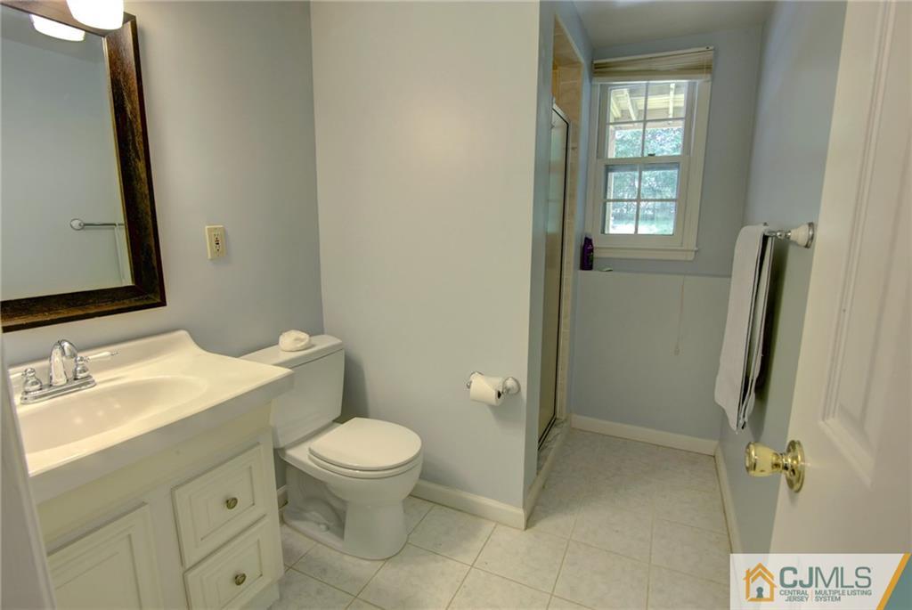 50 Wallace Road Middletown, NJ 07748 - Photo 23 of 24 a bathroom with a granite countertop toilet sink and a mirror