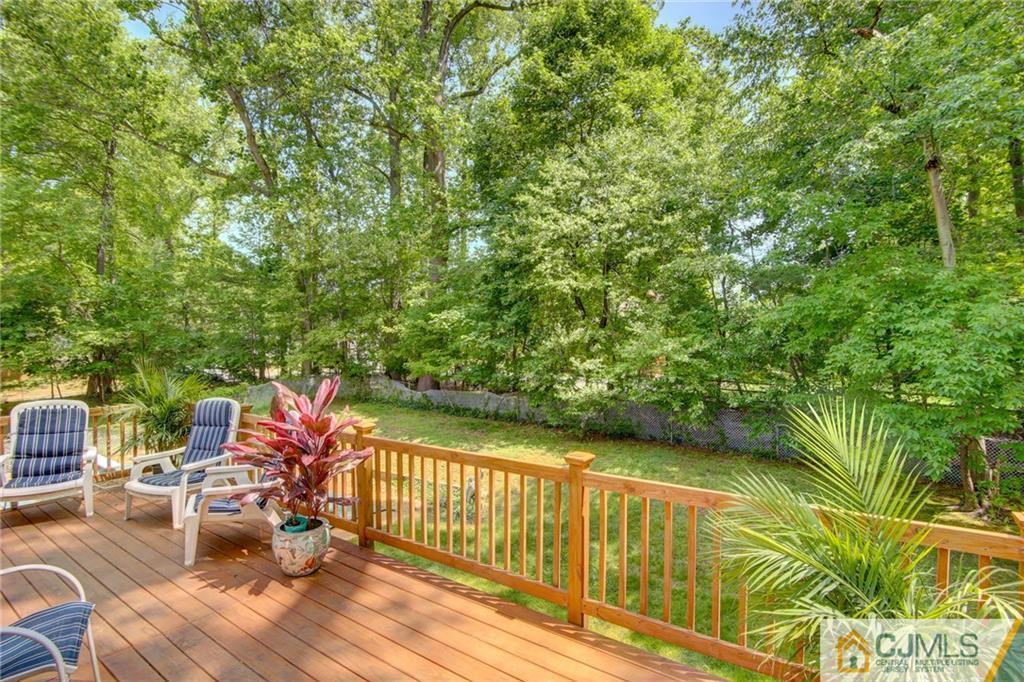 50 Wallace Road Middletown, NJ 07748 - Photo 5 of 24 a balcony with wooden floor and outdoor seating