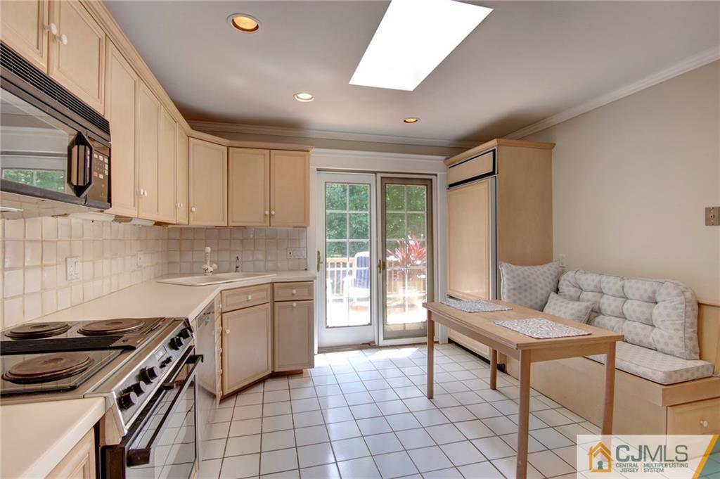 50 Wallace Road Middletown, NJ 07748 - Photo 9 of 24 a kitchen with a stove a sink and a microwave