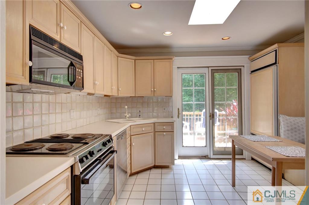 50 Wallace Road Middletown, NJ 07748 - Photo 10 of 24 a kitchen with a stove a sink and a refrigerator