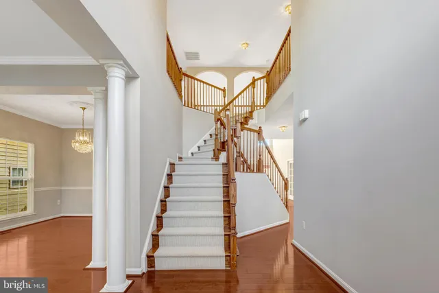 a view of empty room with wooden floor and fireplace