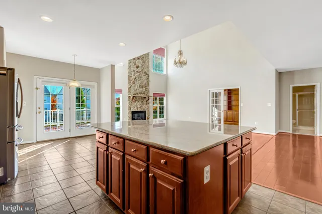 an empty room with a window and a ceiling fan