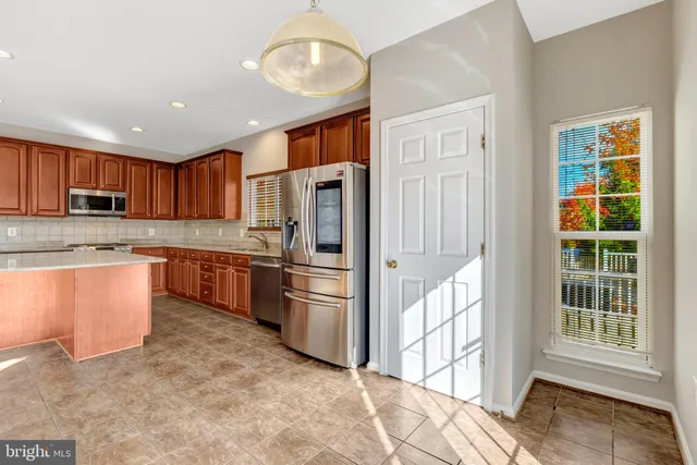an empty room with windows and ceiling fan