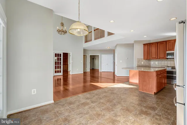 a bathroom with a granite countertop sink a mirror and a bathtub