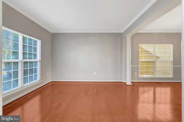 a dining room with furniture a chandelier and wooden floor