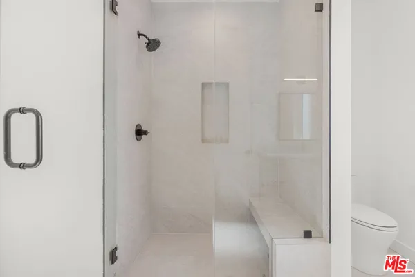 a bathroom with a shower and toilet