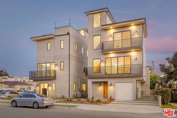 a front view of a residential apartment building with a yard
