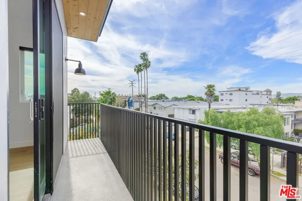 a view of a balcony with wooden floor and fence