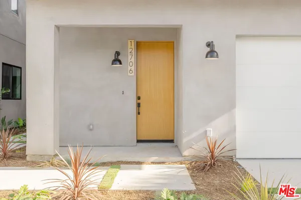 a view of a room that has a bed in it and a wooden floor