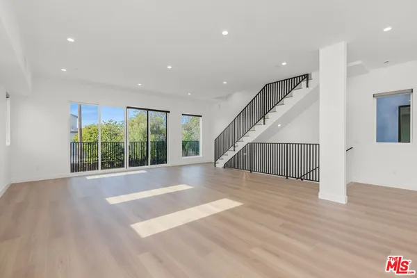 a view of an entryway with wooden floor