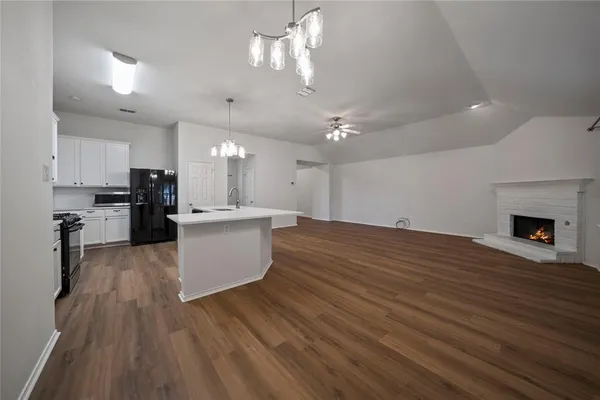 a view of kitchen with cabinets appliances and wooden floor
