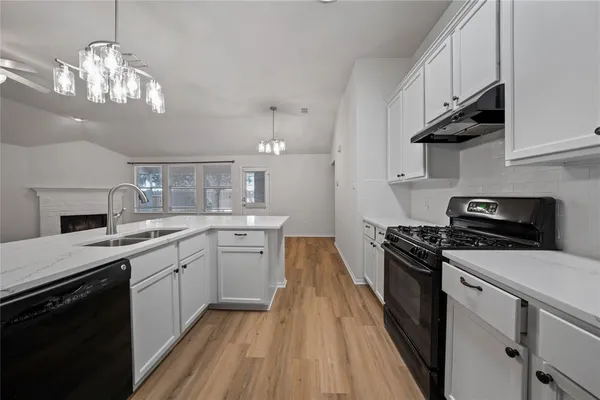 a kitchen with stainless steel appliances a stove sink and cabinets