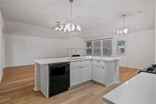 a view of livingroom kitchen with wooden floor and ceiling fan
