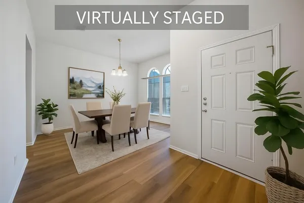 a view of a dining room with furniture and a potted plant