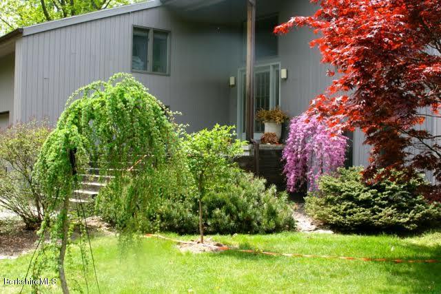222 Whitman Road Hancock, MA 01267 - Photo 5 of 36 a flower garden in front of a house