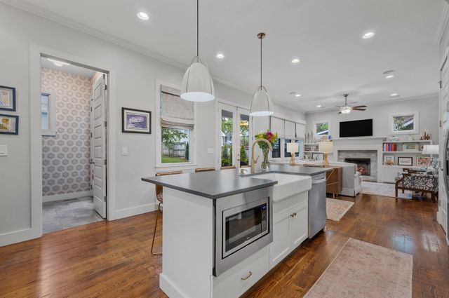 a kitchen with stainless steel appliances granite countertop a stove a cabinets and a window