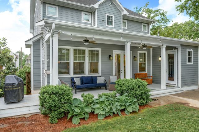 a front view of a house with yard and green space
