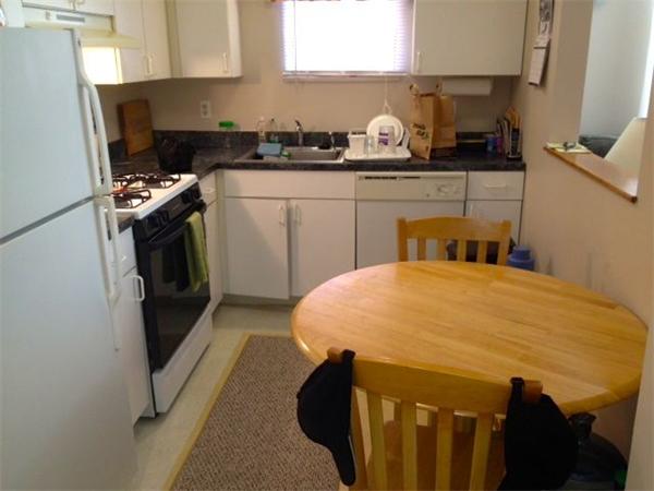 985 Tremont Street, Unit 985 Boston, MA 02120 - Photo 4 of 12 a kitchen with a sink a stove and refrigerator