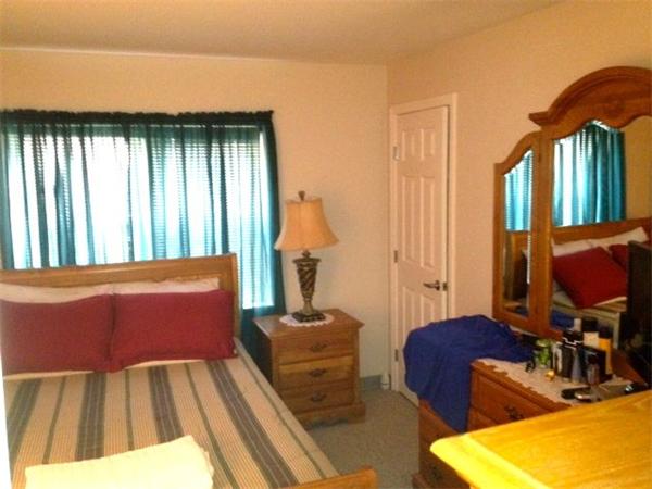 985 Tremont Street, Unit 985 Boston, MA 02120 - Photo 7 of 12 a bedroom with furniture and a window