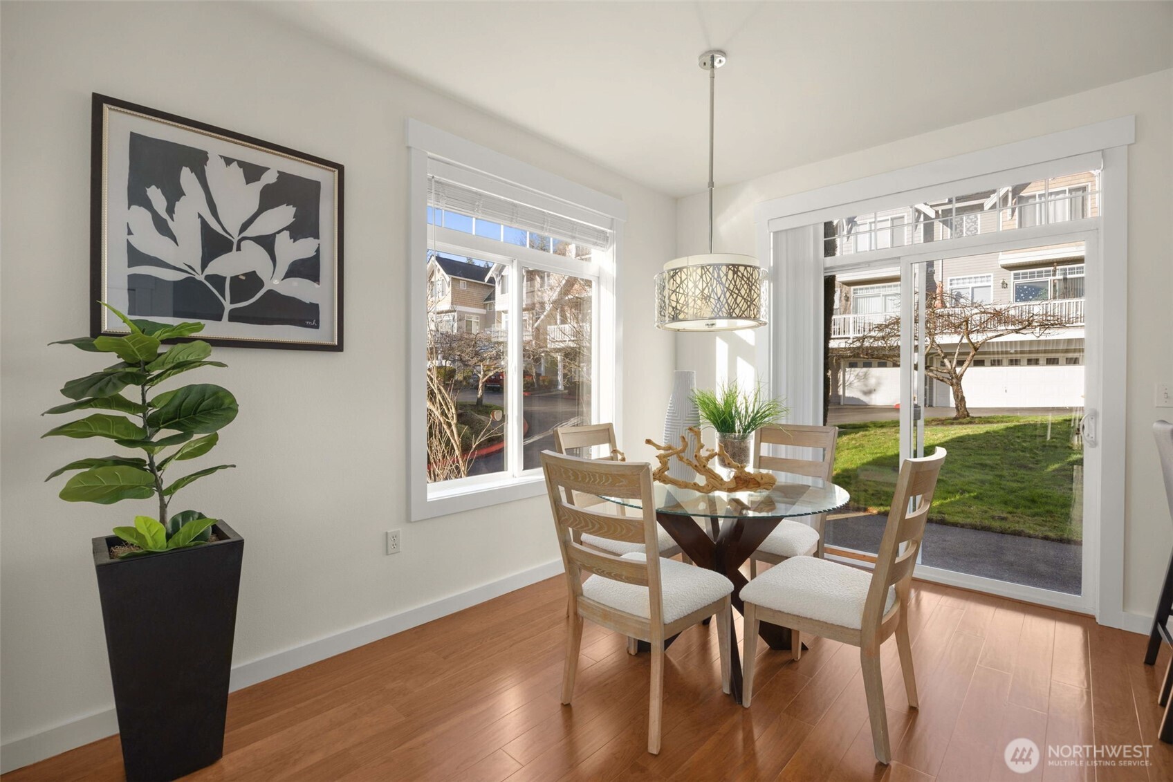 23120 Southeast Black Nugget Road, Unit C1 Issaquah, WA 98029 - Photo 7 of 31 a dining room with furniture potted plants and wooden floor
