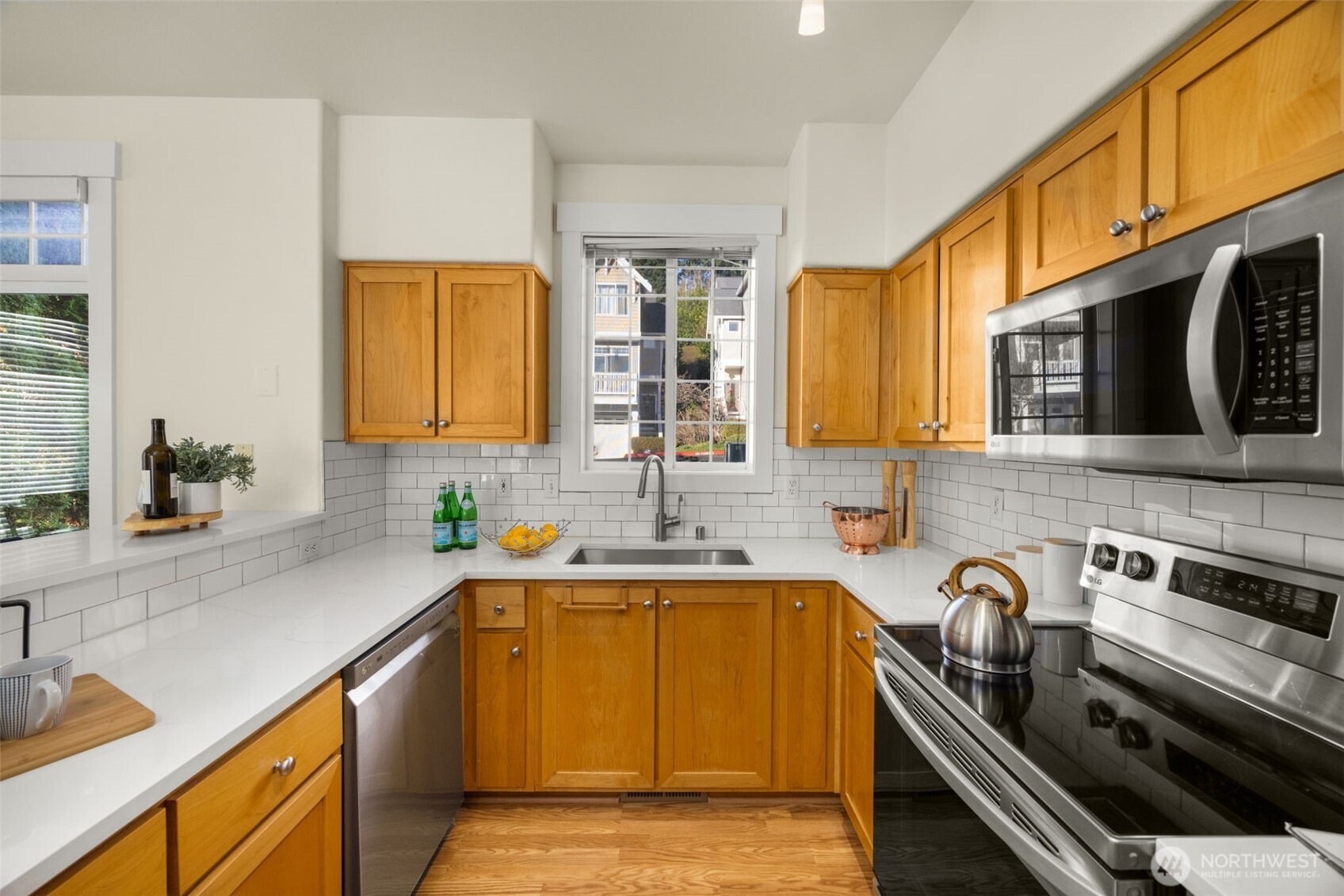 23120 Southeast Black Nugget Road, Unit C1 Issaquah, WA 98029 - Photo 9 of 31 a kitchen with a sink and a stove top oven