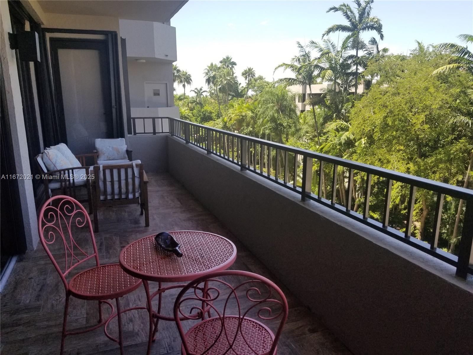 151 Crandon Boulevard, Unit 430 Key Biscayne, FL 33149 - Photo 1 of 26 a balcony with table and chairs
