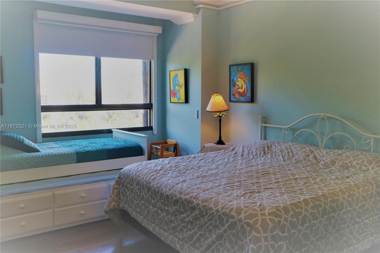 151 Crandon Boulevard, Unit 430 Key Biscayne, FL 33149 - Photo 12 of 26 a bedroom with a bed and a window