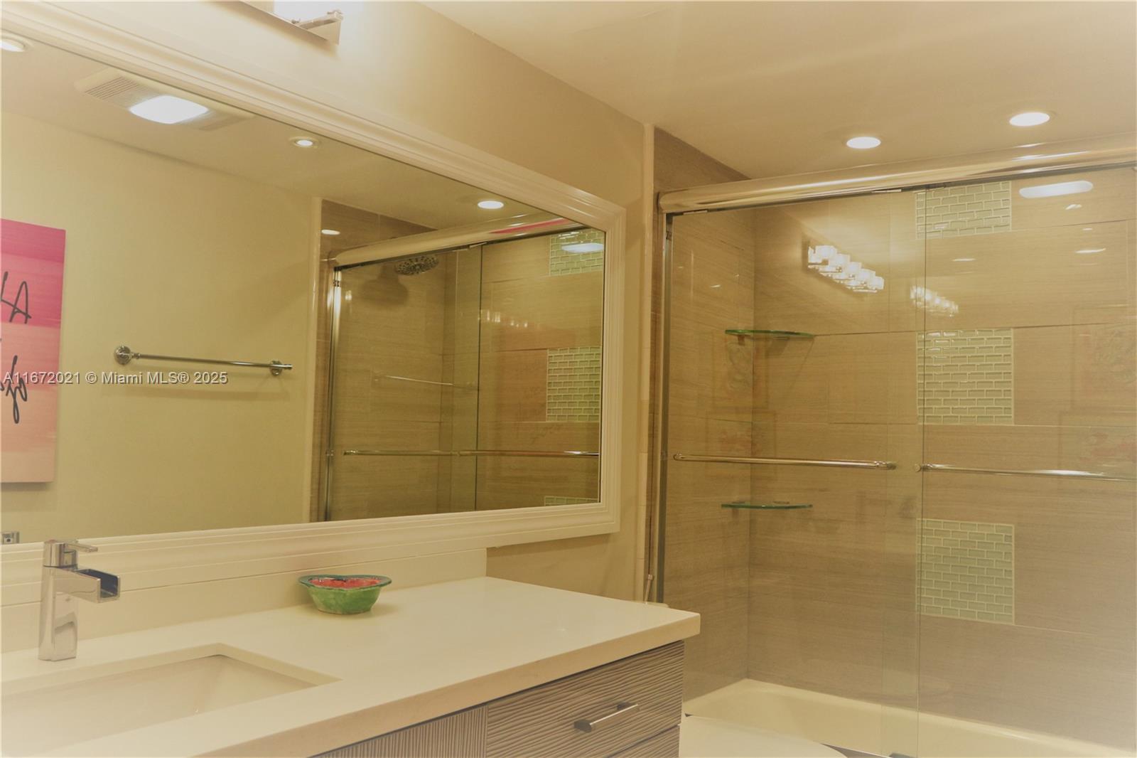 151 Crandon Boulevard, Unit 430 Key Biscayne, FL 33149 - Photo 15 of 26 a bathroom with a sink and a shower