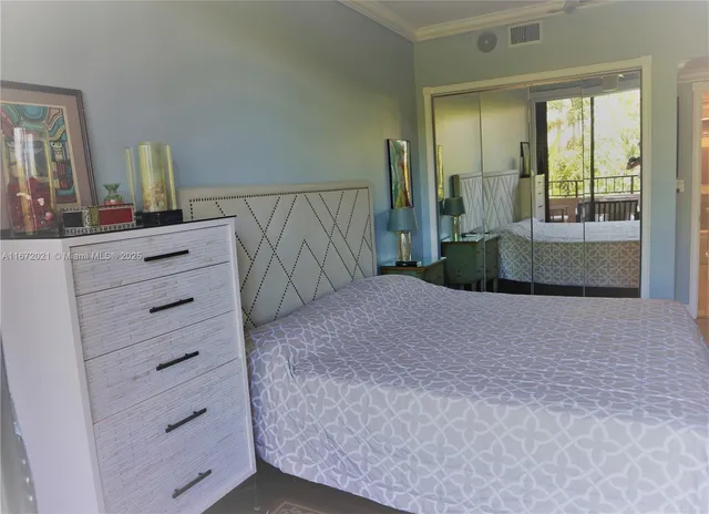 a bedroom with a bed and a mirror