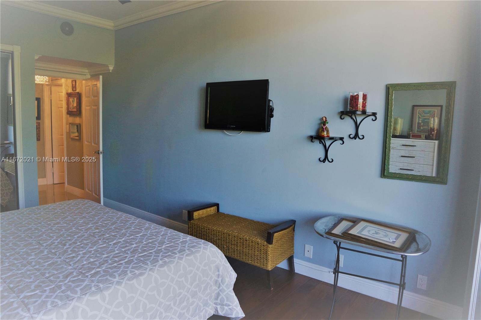 151 Crandon Boulevard, Unit 430 Key Biscayne, FL 33149 - Photo 17 of 26 a bedroom with a bed and a television