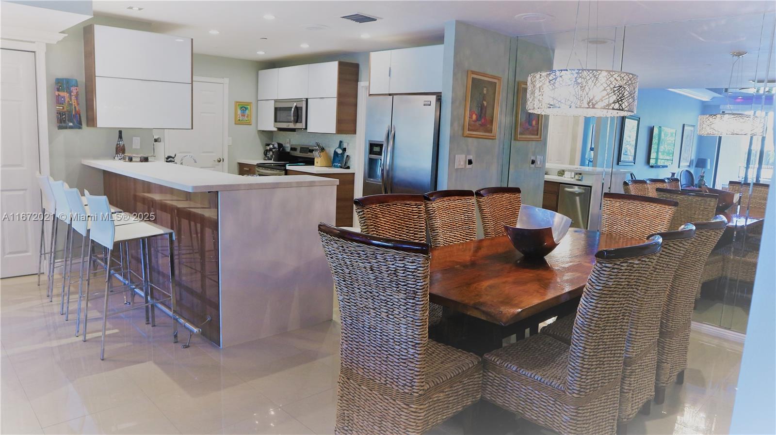 151 Crandon Boulevard, Unit 430 Key Biscayne, FL 33149 - Photo 2 of 26 a living room with stainless steel appliances kitchen island granite countertop furniture a sink a refrigerator and a microwave