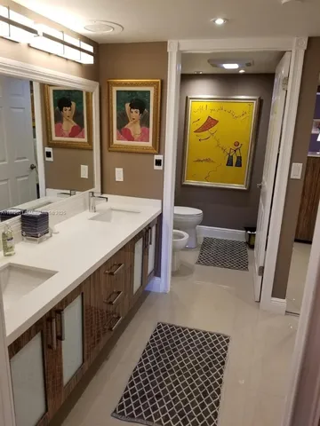 a bathroom with a sink a vanity and a mirror