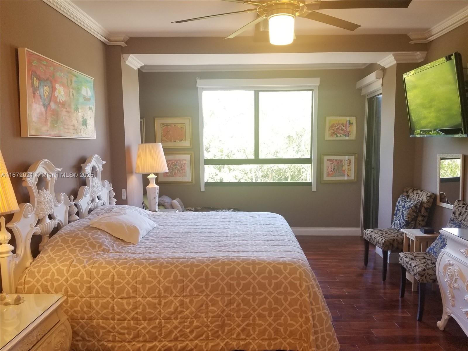 151 Crandon Boulevard, Unit 430 Key Biscayne, FL 33149 - Photo 10 of 26 a bedroom with a bed and wooden floor