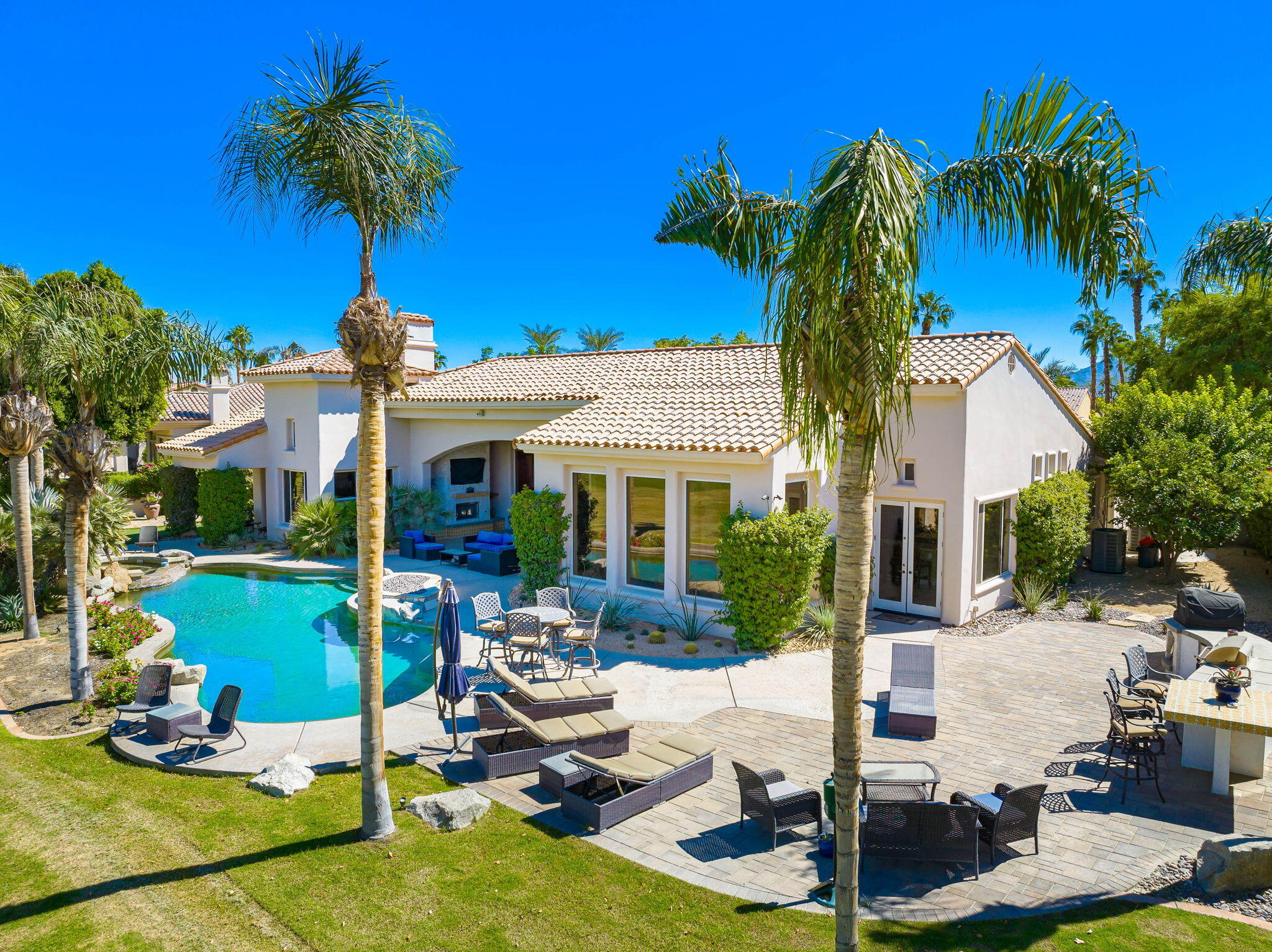 79290 Cetrino La Quinta, CA 92253 - Photo 12 of 74 a front view of a house with garden and patio