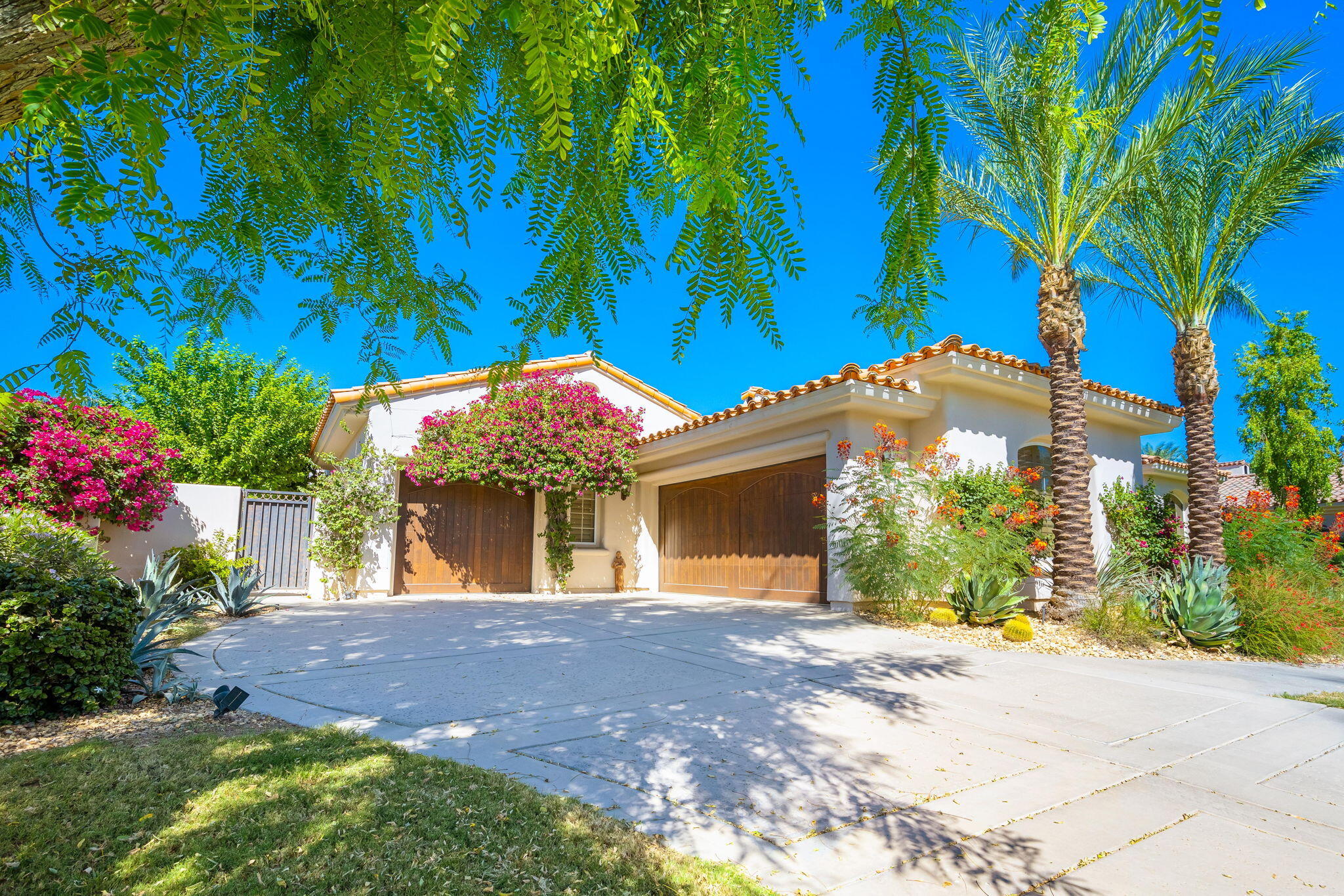 79290 Cetrino La Quinta, CA 92253 - Photo 14 of 74 a front view of a house with a yard and garage