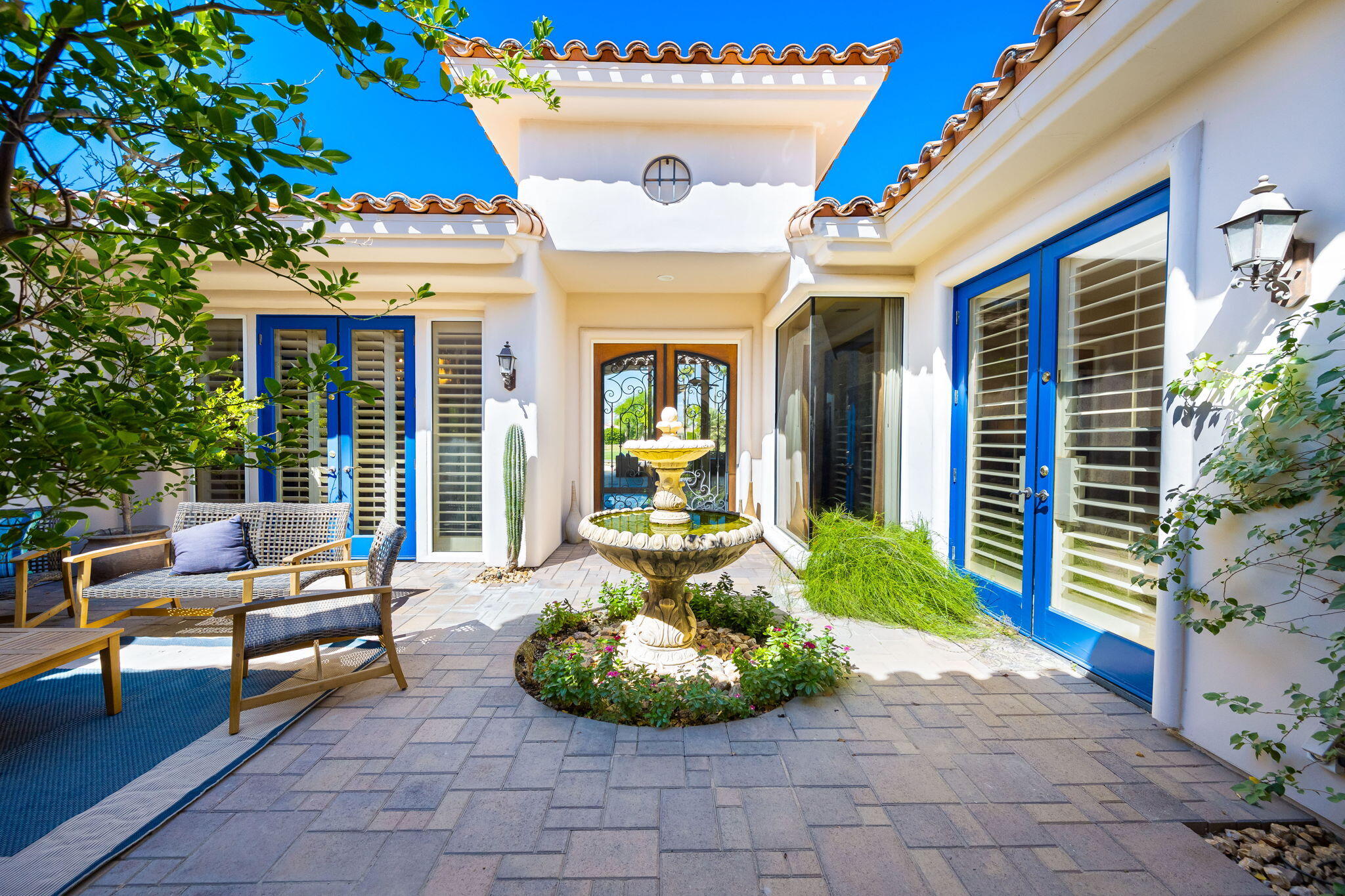 79290 Cetrino La Quinta, CA 92253 - Photo 17 of 74 a view of a patio with table and chairs potted plants and floor to ceiling window and potted plants
