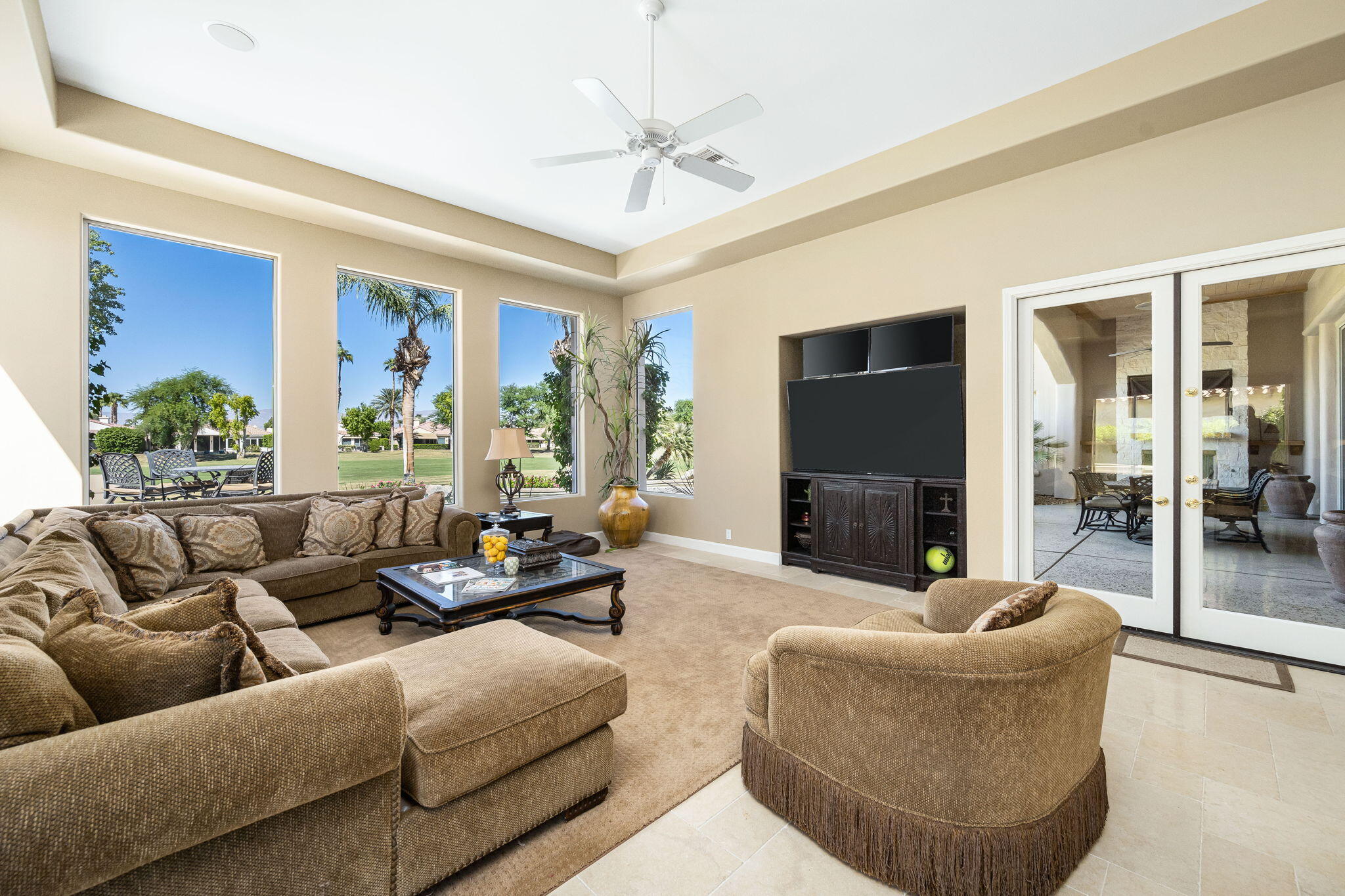 79290 Cetrino La Quinta, CA 92253 - Photo 23 of 74 a living room with furniture a fireplace and a flat screen tv