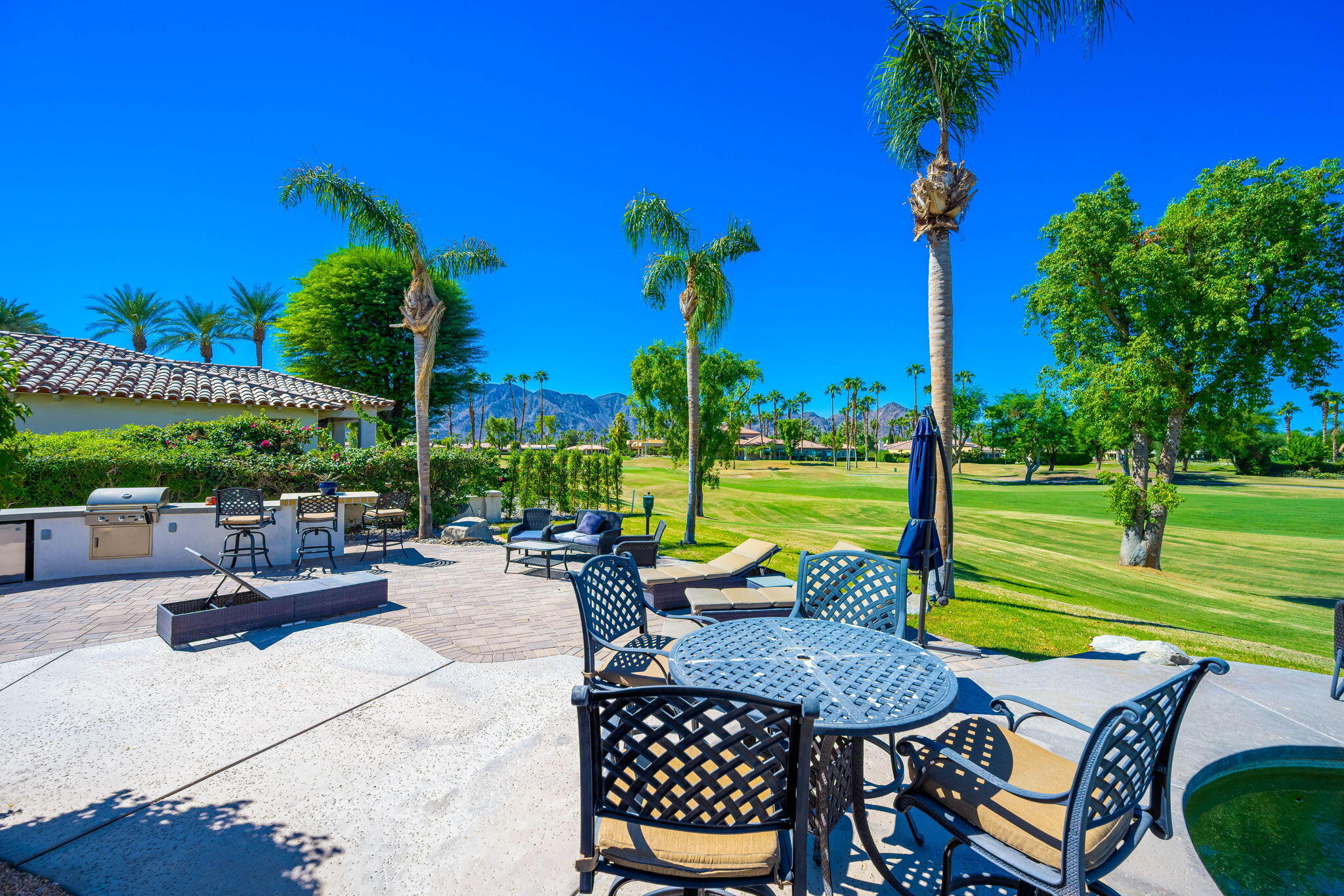 79290 Cetrino La Quinta, CA 92253 - Photo 47 of 74 a view of a patio with a table chairs and a fire pit