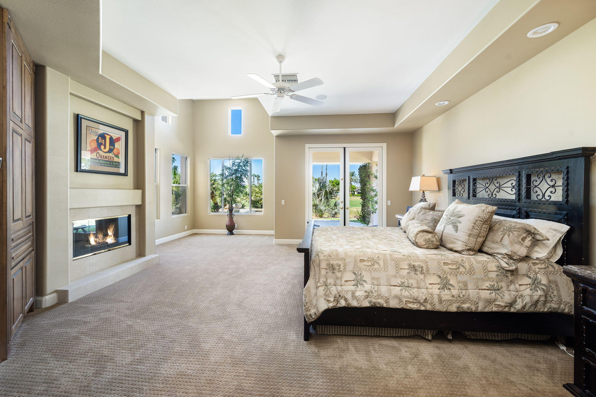 79290 Cetrino La Quinta, CA 92253 - Photo 58 of 74 a bedroom with a large bed and a fireplace