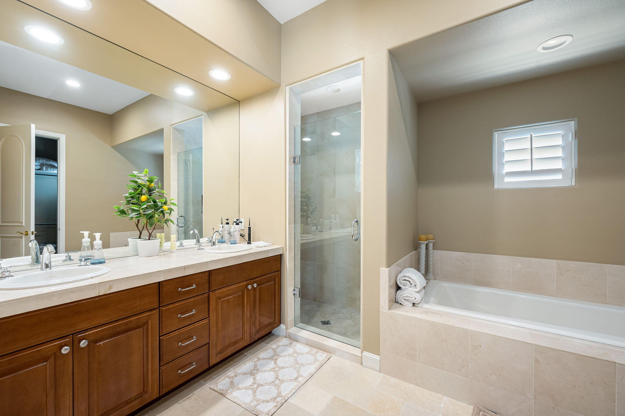 79290 Cetrino La Quinta, CA 92253 - Photo 69 of 74 a bathroom with a tub double sink shower and mirror
