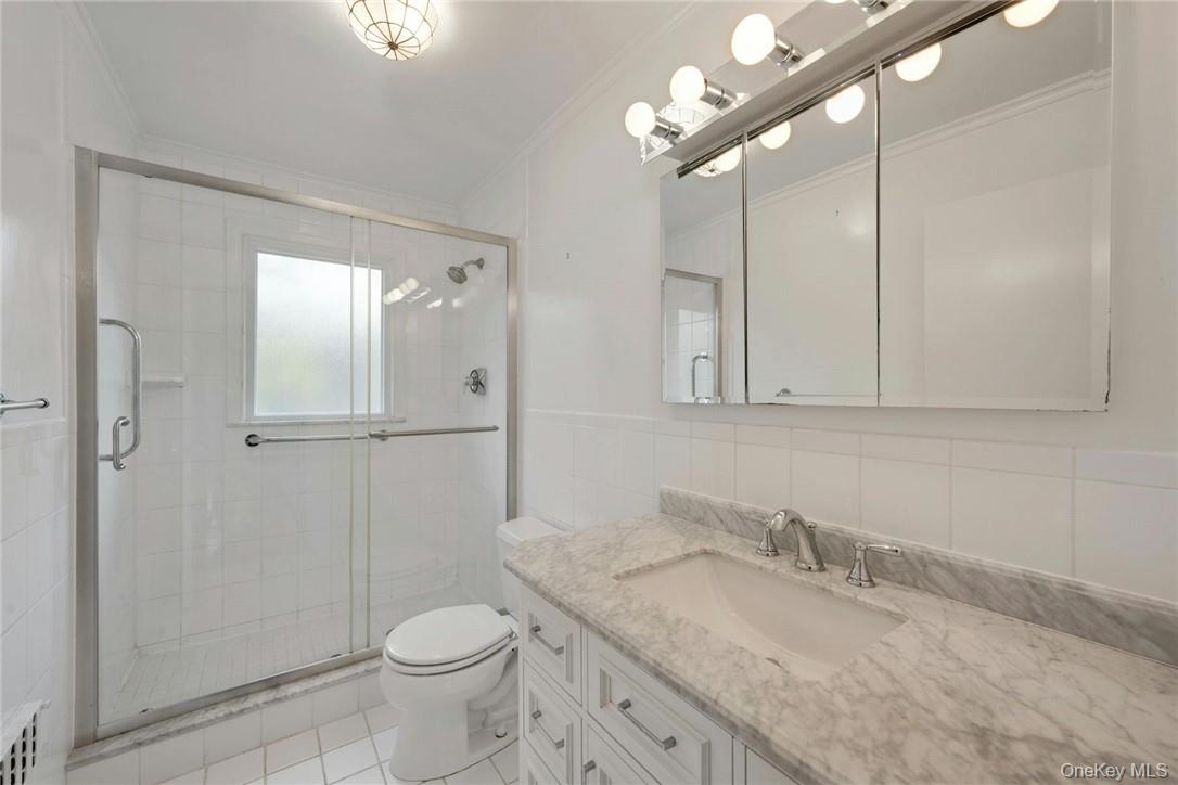 29 Old Orchard Road Rye Brook, NY 10573 - Photo 14 of 32 a bathroom with a granite countertop sink a toilet and shower
