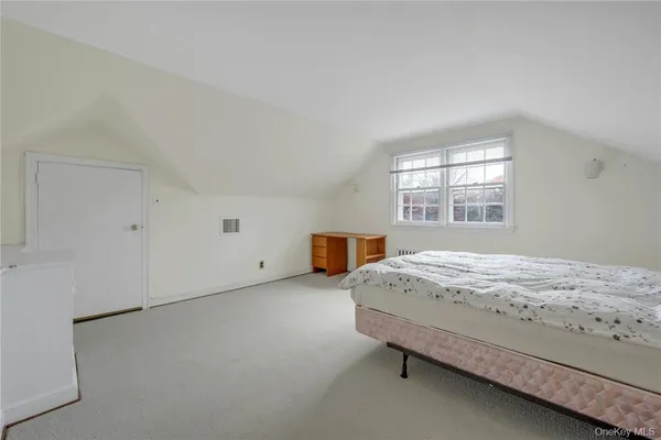 a bedroom with a bed and window