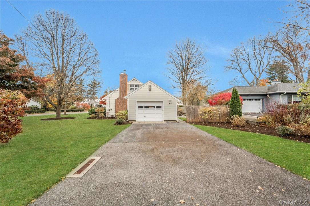 29 Old Orchard Road Rye Brook, NY 10573 - Photo 28 of 32 a view of white house with a yard and large tree