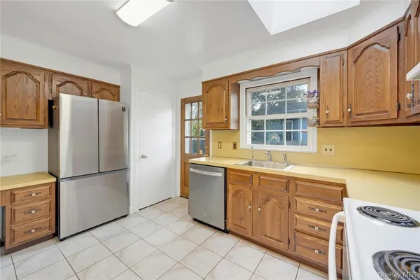 a kitchen with stainless steel appliances granite countertop a refrigerator and a sink