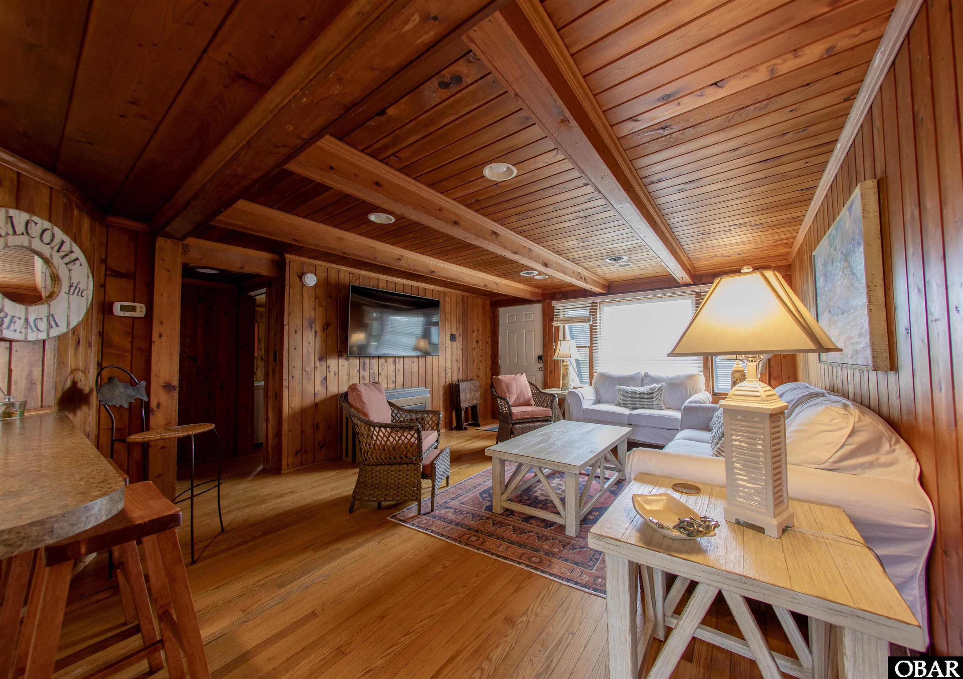 41 Skyline Road, Unit 1 Southern Shores, NC 27949 - Photo 9 of 58 Living room with TV and fold-out dining table.