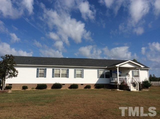 985 Mitchell Road Angier, NC 27501 - Photo 1 of 18 a front view of a house with a garden