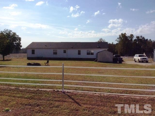 985 Mitchell Road Angier, NC 27501 - Photo 2 of 18 a view of a house with a big yard and large trees