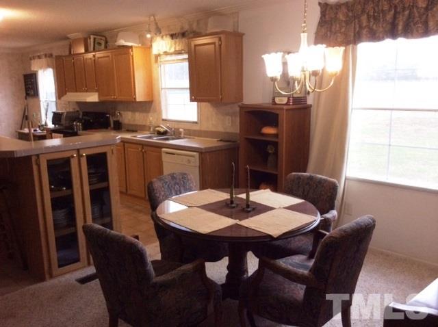 985 Mitchell Road Angier, NC 27501 - Photo 4 of 18 a kitchen with a dining table chairs and a counter top space