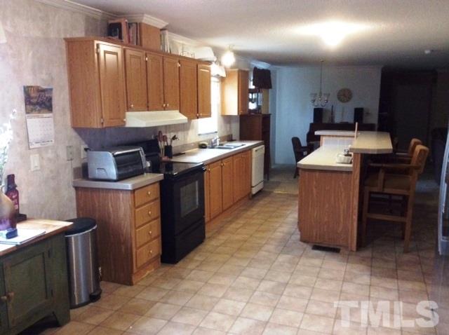 985 Mitchell Road Angier, NC 27501 - Photo 5 of 18 a kitchen with kitchen island cabinets and white appliances